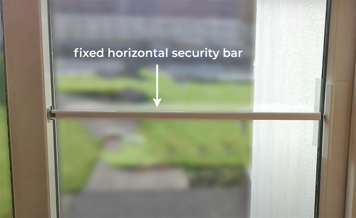 Sliding door fixed security bar