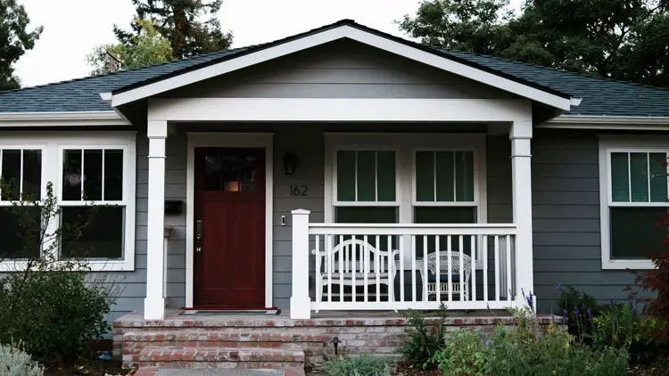 Dark gray house with copper penny front door