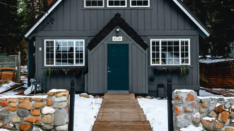 Gray house with dark sky blue door