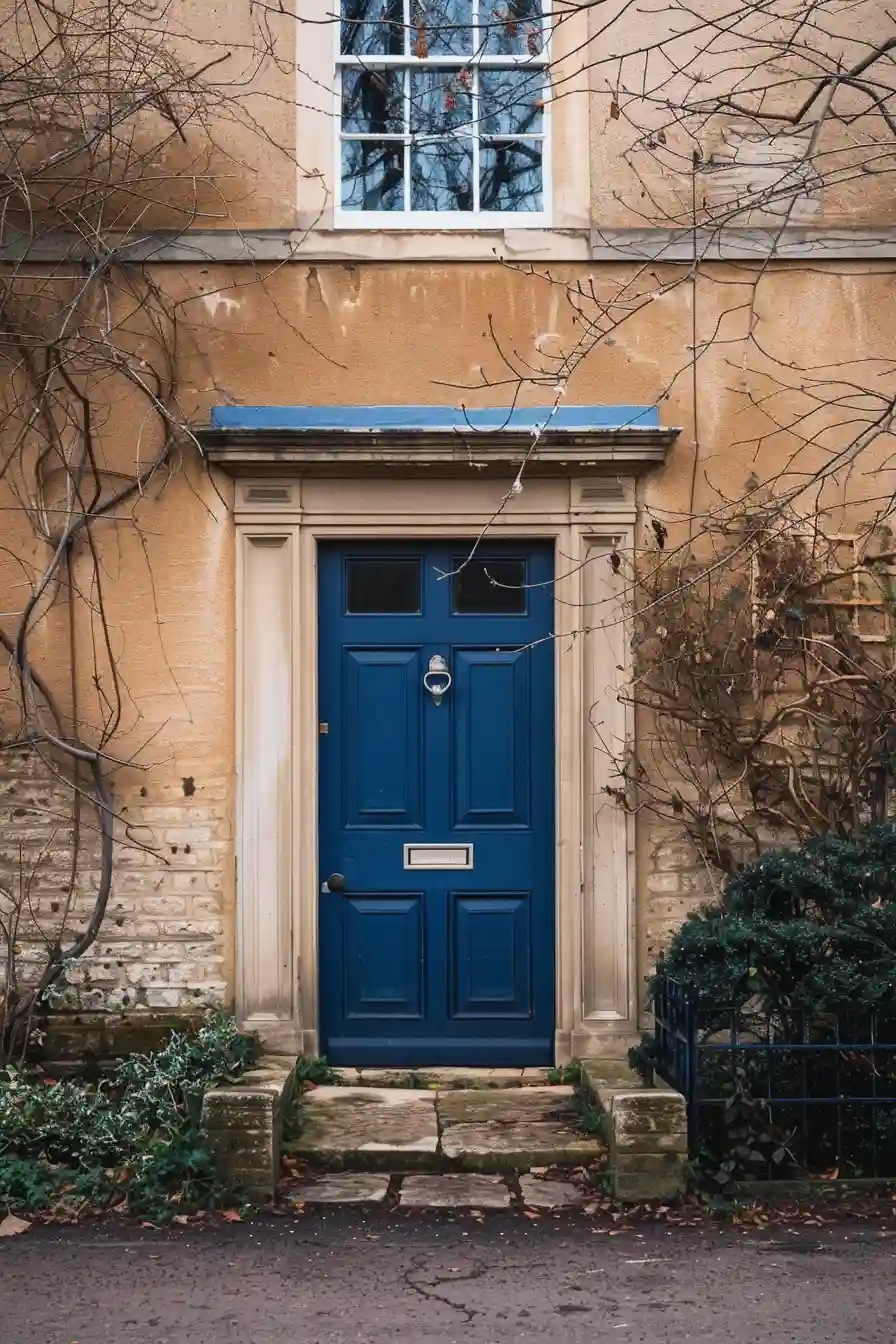 Tan house with navy blue front door