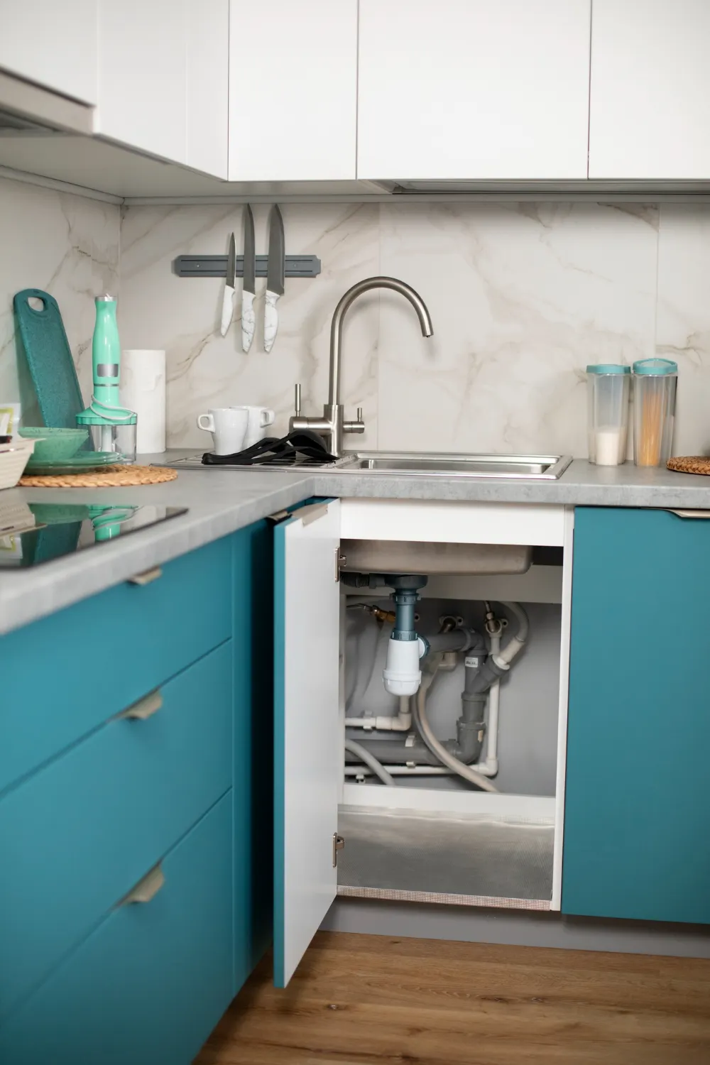 a kitchen with a kitchen sink: P-trap is visible underneath